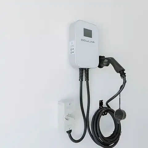 A new Ocular EV charger mounted on a white wall with its cable coiled