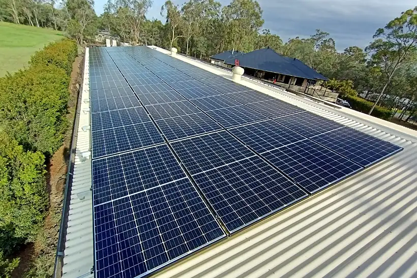 A long solar array on a shed roof at Park Ridge, receding towards a house roof