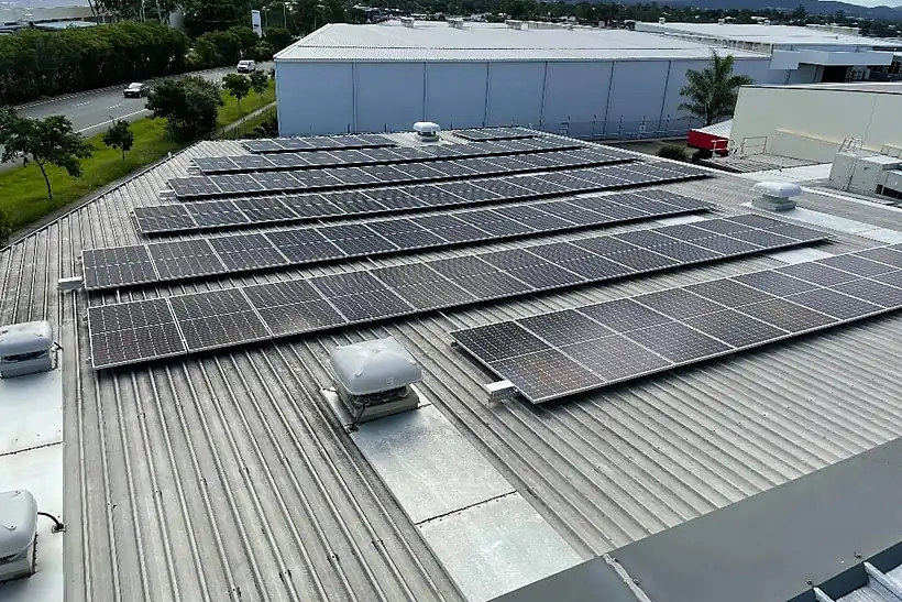 Panel rows on the Lucas Papaw roof with an industrial estate and mountains behind
